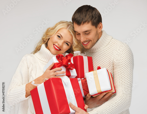 Photo: romantic couple in a sweaters with gift boxes romantic couple in a sweaters with gift boxes