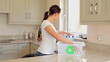 Woman putting bottles into recycling bin