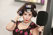 Woman in Curlers Holding Mirror