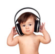 Adorable baby girl with big headphones