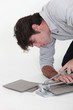 Man using a tile cutter