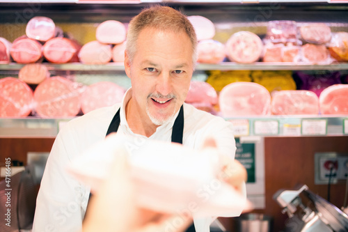 Photo: Shopkeeper serving a customer Shopkeeper serving a customer
