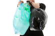 Young man carrying a plastic trash bags.
