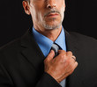 Businessman adjusting his necktie