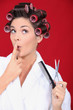 Woman in bath robe wearing hair rollers