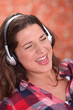 Brunette wearing headphones and singing