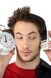 Man holding alarm clock and mobile telephone
