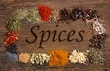 Different spices over a wooden background.