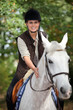 young horsewoman with white horse