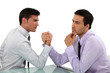 handsome businessmen arm wrestling