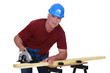 Carpenter using an electric saw
