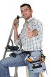 Carpenter stood with ladder
