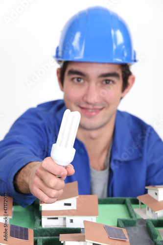 Photo: Tradesman holding a fluorescent lamp Tradesman holding a fluorescent lamp