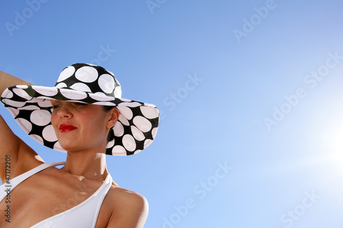 Photo: Chic woman in bikini and spotty hat Chic woman in bikini and spotty hat