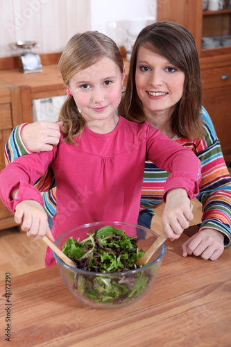 Photo: Mother and daughter making a salad together Mother and daughter making a salad together