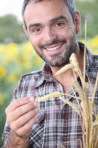 Photo: Closeup of smiling man in a cornfield Closeup of smiling man in a cornfield