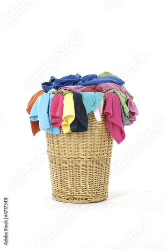 Photo: Full of colorful shirts in a wicker basket Full of colorful shirts in a wicker basket