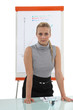 Assertive blond woman stood by flip-chart