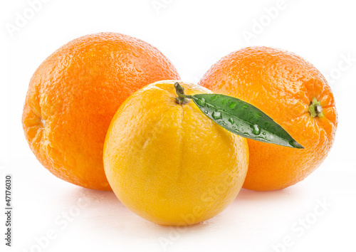 Photo: Ripe orange fruit with leaf and water drops isolated on white Ripe orange fruit with leaf and water drops isolated on white