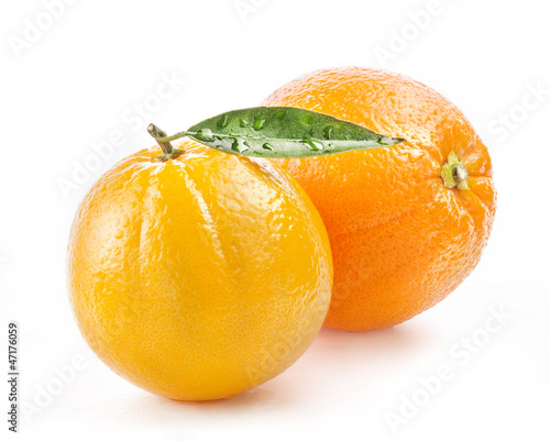 Photo: Ripe orange fruit with leaf and water drops isolated on white Ripe orange fruit with leaf and water drops isolated on white