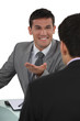 Businessman telling a joke to colleague