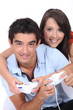 Young couple playing video games together