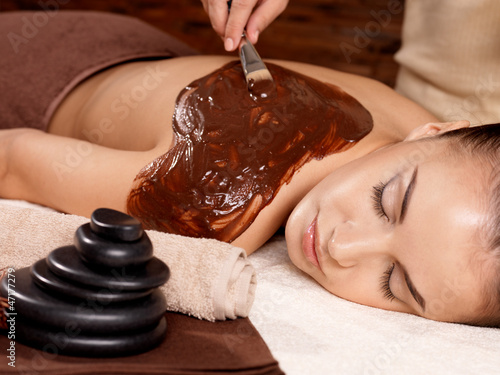 Photo: Spa therapy for young woman receiving cosmetic mask Spa therapy for young woman receiving cosmetic mask