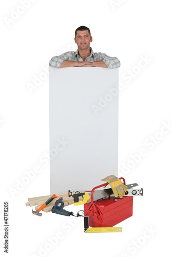 Photo: Carpenter with a blank board Carpenter with a blank board