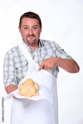 Photo: Butcher pointing at chicken Butcher pointing at chicken