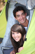Photo: Teens leaning in tent Teens leaning in tent