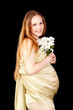 The happy pregnant woman with a bouquet of chrysanthemums