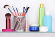 Shelf with cosmetics and toiletries in bathroom