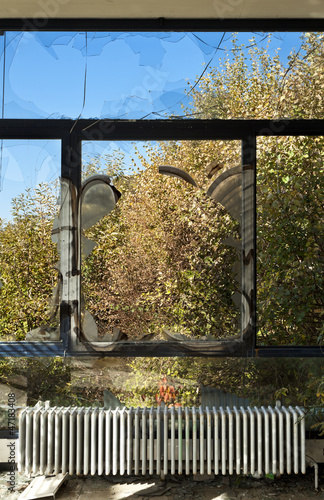 Photo: window view and old radiator, abandoned building window view and old radiator, abandoned building