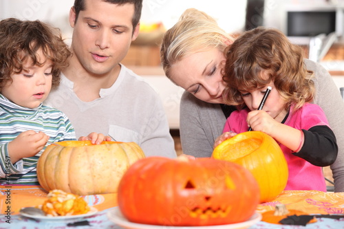 Photo: Family sculpting pumpkins Family sculpting pumpkins
