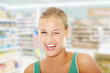 Foto: Happy young blond woman blinking. Happy young blond woman blinking.