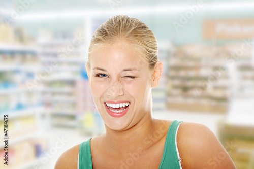 Photo: Happy young blond woman blinking. Happy young blond woman blinking.