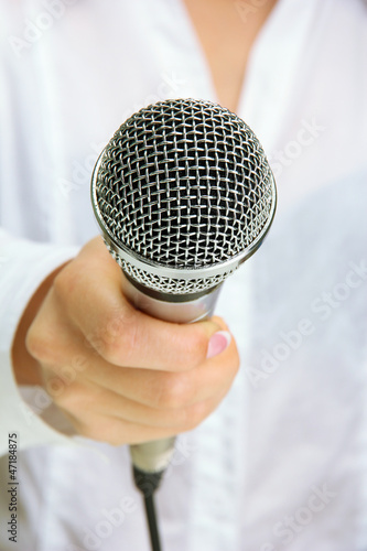 Photo: female with microphone, close up female with microphone, close up
