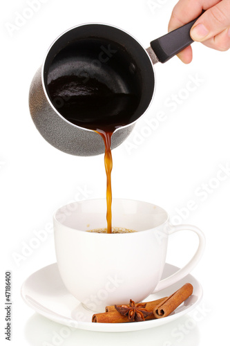 Photo: Pouring coffee in cup isolated on white Pouring coffee in cup isolated on white