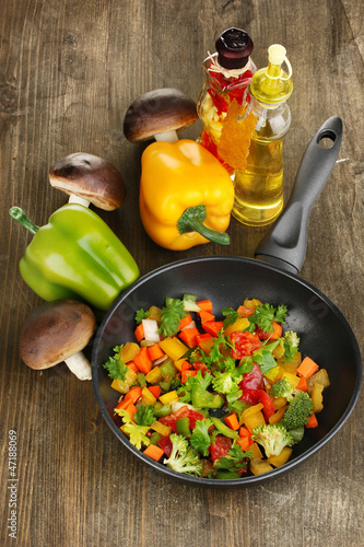 Photo: Sliced fresh vegetables in pan with spices and ingredients Sliced fresh vegetables in pan with spices and ingredients