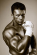 Fighter holds hands clenched in fists before himself.