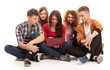 Group of students talking and holding notebooks