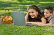 Photo: mom and child with laptop outdoors mom and child with laptop outdoors
