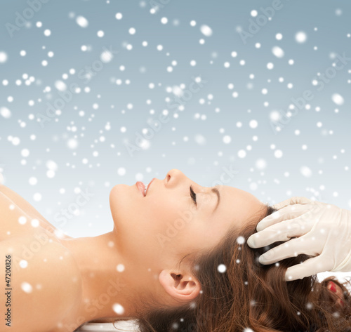 Photo: beautiful woman in massage salon with snow beautiful woman in massage salon with snow