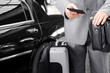 Traveling Businessman with His Luggage Using Phone