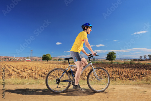 Photo: Biker in yellow shirt riding a bike Biker in yellow shirt riding a bike