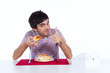Foto: Young man eating a cake Young man eating a cake