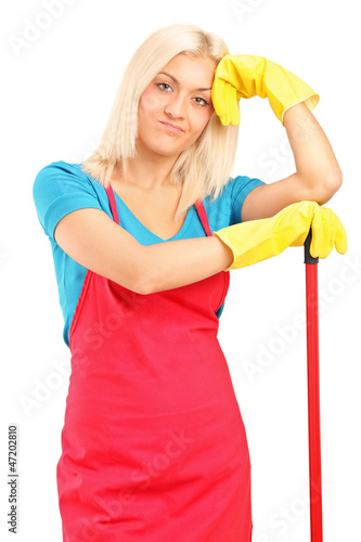 Photo: Exhausted female cleaner posing with brush Exhausted female cleaner posing with brush