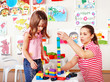 Foto: Child playing construction set with mother. Child playing construction set with mother.