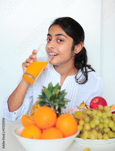 Photo: Beautiful girl holding fruits and a measure tape Beautiful girl holding fruits and a measure tape