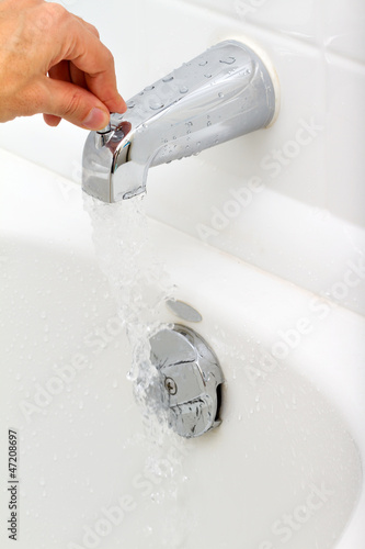 Photo: Demonstration of how the water tap is working in a bathroom Demonstration of how the water tap is working in a bathroom
